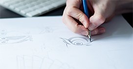 Alex Huntly sketching a logo.